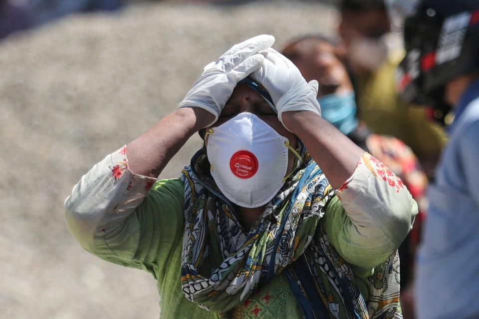 A relative of a person who died of COVID-19 reacts at a crematorium in Jammu, India, on April 25, 2021.