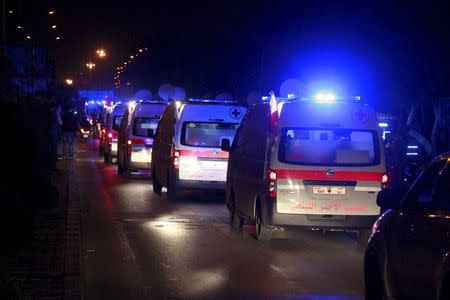 A convoy of Red Cross ambulances carrying rebel fighters from the besieged rebel-held Syrian town of Zabadani arrive at the Beirut international airport for the fighters to board a plane to Turkey, December 28, 2015. REUTERS/Aziz Taher