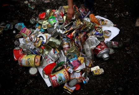 Workers from a recycling company display the garbage collected and brought from Mount Everest in Kathmandu