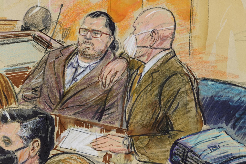 This artist sketch depicts Guy Wesley Reffitt, joined by his lawyer William Welch, right, in Federal Court, in Washington, Monday, Feb. 28, 2022. Reffitt, a Texas man charged with storming the U.S. Capitol with a holstered handgun on his waist, is the first Jan. 6 defendant to go on trial. (Dana Verkouteren via AP)