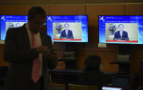 In this photo released by Malaysia Department of Information, screens show Japan's Prime Minister Yoshihide Suga delivering a speech via virtual meeting during the APEC CEO Dialogues 2020, ahead of the Asia-Pacific Economic Cooperation (APEC) leaders' summit in Kuala Lumpur, Malaysia, Friday, Nov. 20, 2020. (Fandy Azlan/Malaysia Department of Information via AP)