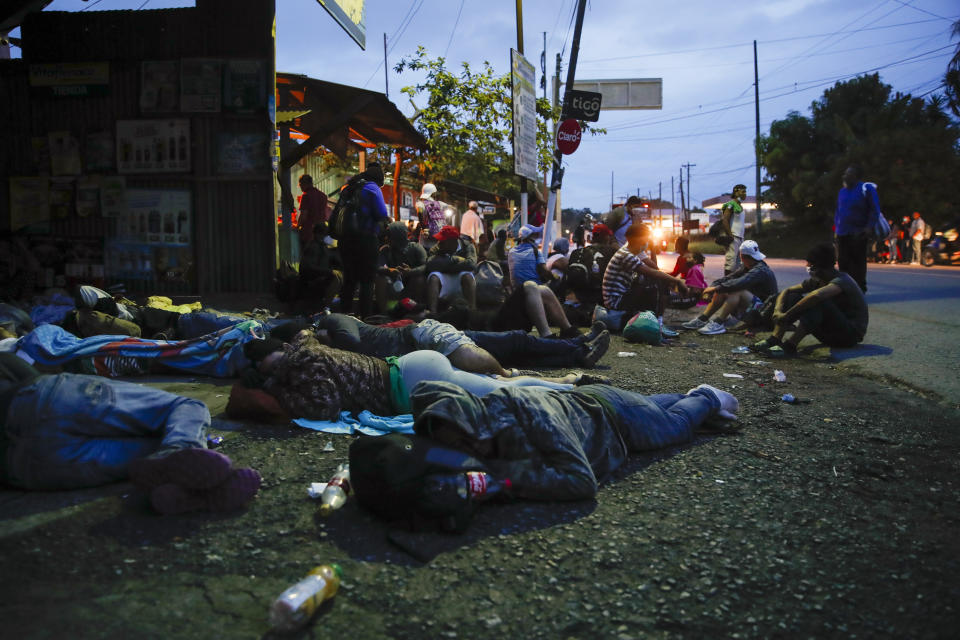 Honduran migrants rest in Puerto Barrios, Guatemala, Friday, Oct. 2, 2020. About 2,000 Honduran migrants hoping to reach the United States entered Guatemala on foot Thursday, but Guatemalan President Alejandro Giammattei vowed to detain them and return them to their home country saying they represented a health threat amid efforts to contain the coronavirus pandemic. (AP Photo/Moises Castillo)