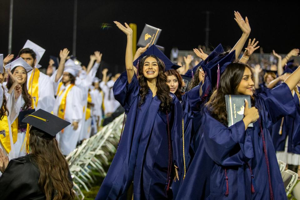 La Quinta High School Class of 2024 graduating seniors wave to acknowledge their guardians and supporters during the commencement ceremony at the school in La Quinta, Calif., on Thurs., May 23, 2024.