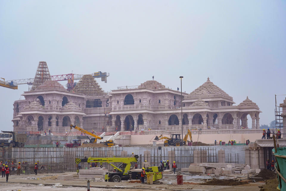 FILE - A construction crew works on Ram Mandir, a Hindu temple dedicated to Lord Ram in Ayodhya, India, on Jan. 16, 2024. Spread over an area of nearly 3 hectares, the Ram temple will be a three-story structure made in pink sandstone with intricate wall carvings and 46 doors — 42 of which will have a layer of gold totaling around 100 kilograms (220 pounds). The temple is being built at an estimated cost of $217 million, though it is far from complete. (AP Photo/Deepak Sharma, File)