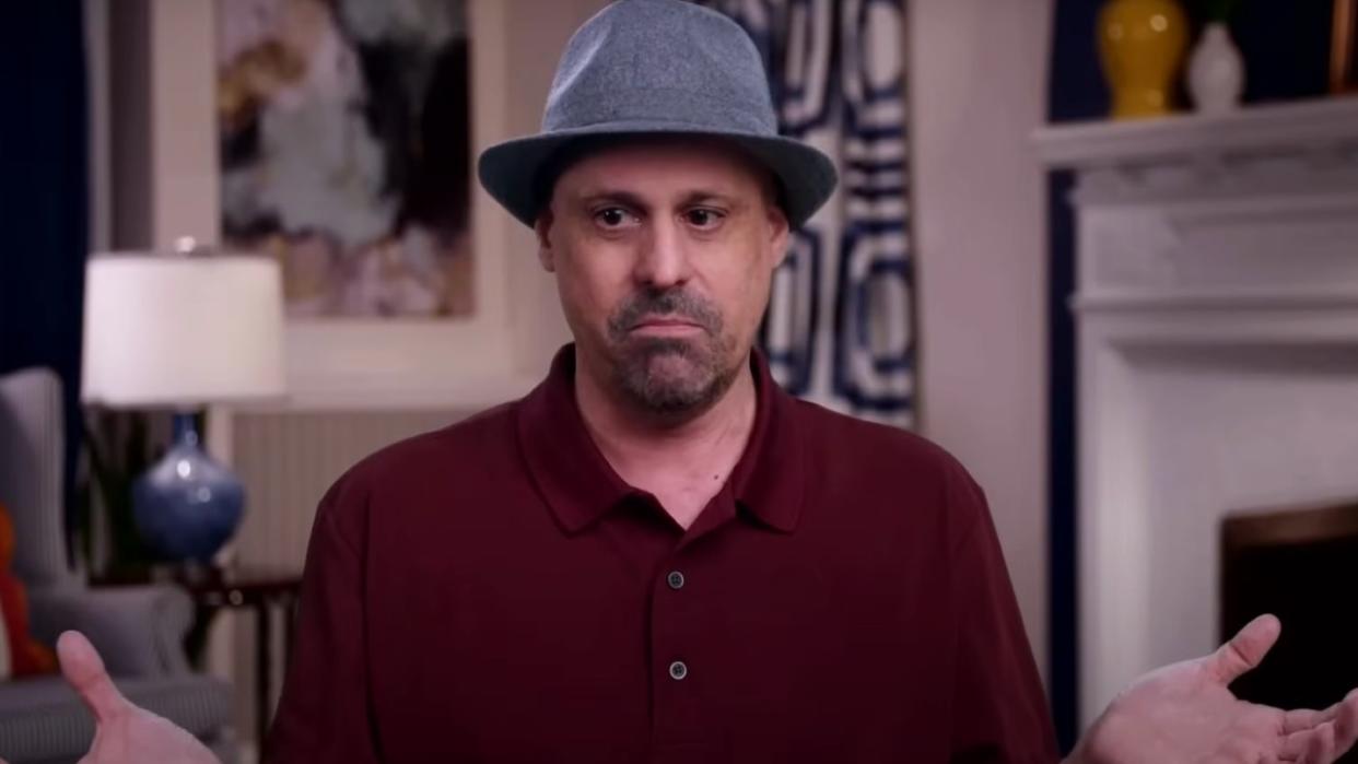  Gino Palazzolo on 90 Day Fiancé wearing a maroon shirt and a fedora. 