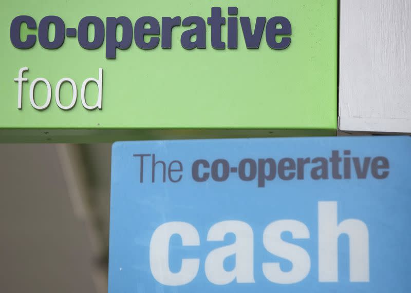 Signs are displayed outside of a branch of a Co-operative food store in north London