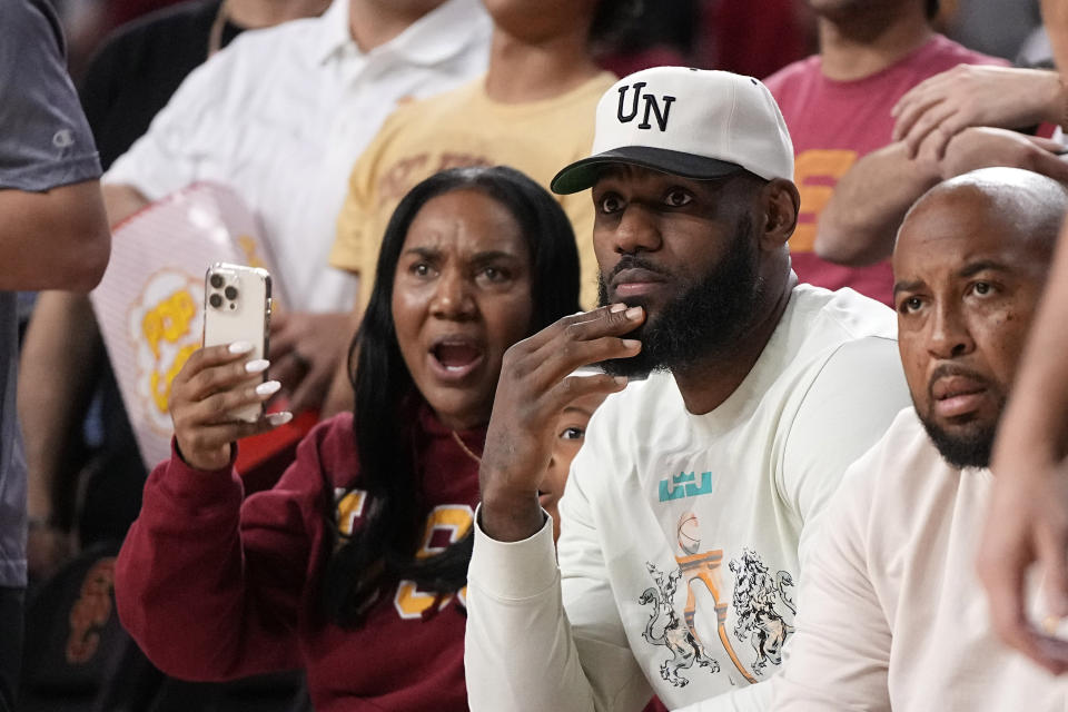 LeBron James watches during the second half of an NCAA college basketball game betwee Southern California and Long Beach State Sunday, Dec. 10, 2023, in Los Angeles. (AP Photo/Mark J. Terrill)