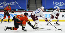 Anaheim Ducks defenseman Ben Hutton, left, knocks the puck away from Colorado Avalanche right wing Joonas Donskoi during the first period of an NHL hockey game Saturday, March 6, 2021, in Denver. (AP Photo/David Zalubowski)