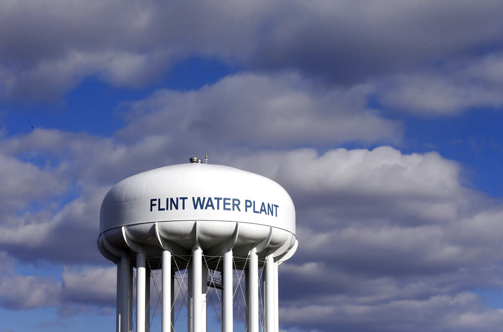 Flint Water Plant tower is shown before a cloudy sky