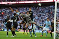 Manchester City's defender Vincent Kompany (L), Wigan's goalkeeper Joel Robles (C) and midfielder James McArthur (R) watch as the ball bobbles over the bar during the English FA Cup final at Wembley Stadium in London on May 11, 2013. Wigan won 1-0