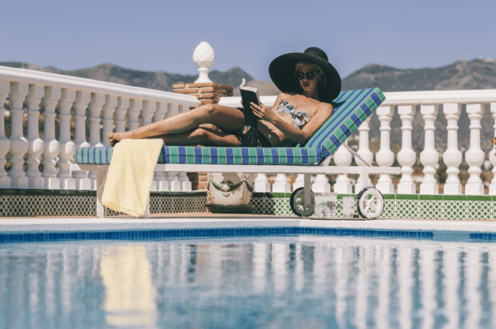 <span class="caption">Perfect poolside fiction.</span> <span class="attribution"><a class="link " href="http://www.shutterstock.com/pic-159543026/stock-photo-young-lady-on-sun-lounger-relaxing-by-the-pool-reading-a-book-in-a-wide-brimmed-hat.html?src=B5o6a6oFsvNjSt5G4VzJPA-1-87" rel="nofollow noopener" target="_blank" data-ylk="slk:EPSTOCK/Shutterstock.com;elm:context_link;itc:0;sec:content-canvas">EPSTOCK/Shutterstock.com</a></span>