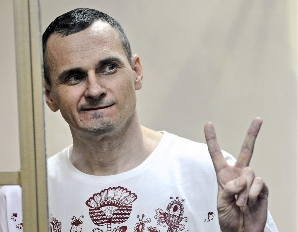 FILE - In this Tuesday, Aug. 25, 2015 file photo, Oleg Sentsov gestures as the verdict is delivered, as he stands behind bars at a court in Rostov-on-Don, Russia. The lawyer for a hunger-striking Ukrainian filmmaker imprisoned in Russia says his client has become increasingly frail. Wednesday, Aug. 8, 2018 marks the 87th day that Oleg Sentsov has been refusing food in a Russian prison. His lawyer Dmitry Dinze said after visiting him Tuesday that Sentsov has a very low hemoglobin level, resulting in anemia and a slow heartbeat of about 40 beats per minute. (AP Photo, file)