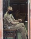 Russian Captain Tyutkalo Vitaly of fire damaged container ship MV X-Press Pearl waits in a court before the hearing begins in Colombo, Sri Lanka. Monday, June 14, 2021. (AP Photo/Eranga Jayawardena)