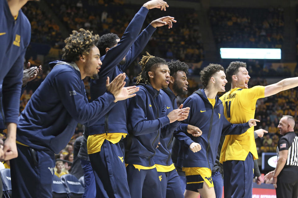 West Virginia players react from the bench during the first half of an NCAA college basketball game against Texas on Saturday, Jan. 13, 2024, in Morgantown, W.Va. (AP Photo/Kathleen Batten)