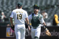 Oakland Athletics pitcher Mason Miller (19) celebrates with catcher Kyle McCann after the Athletics defeated the Pittsburgh Pirates in a baseball game in Oakland, Calif., Wednesday, May 1, 2024. (AP Photo/Jeff Chiu)