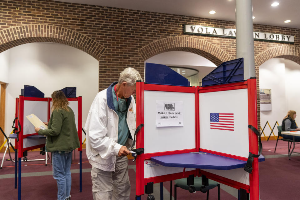 People vote in the election at a polling place at Alexandria City Hall, in Alexandria, Va., Tuesday, Nov. 7, 2023. (AP Photo/Jacquelyn Martin)