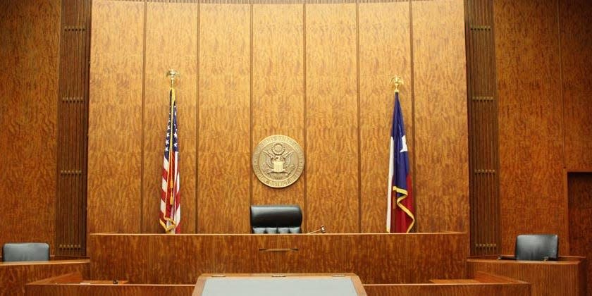 The interior of a Texas courthouse, with US and Texas flags