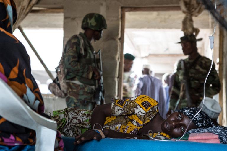 Nigerian soldiers guard a makeshift hospital in Maiduguri on March 25, 2015