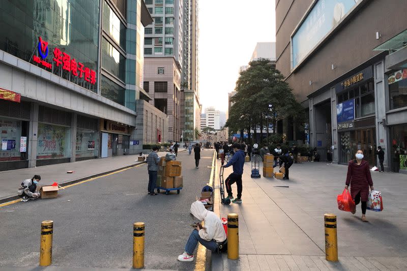 Traders buy and sell chips and components on the streets of Huaqiangbei following an outbreak of the novel coronavirus in the country