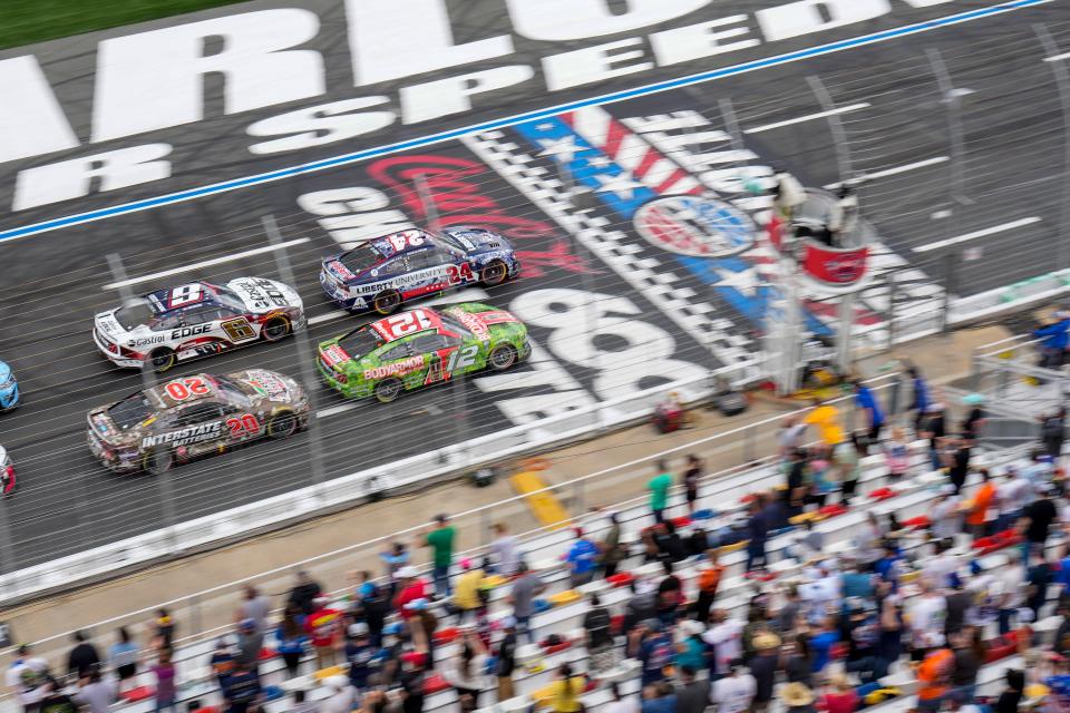 William Byron (24) and Ryan Blaney (12) lead the field past the start/finish line during a restart in the Coca-Cola 600 at Charlotte Motor Speedway on May 29, 2023.