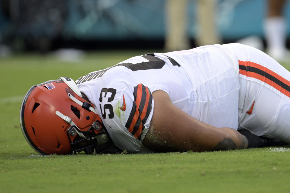 FILE - Cleveland Browns center Nick Harris (53) lays on the turf after he was injured during the first half of an NFL preseason football game, Friday, Aug. 12, 2022, in Jacksonville, Fla. (AP Photo/Phelan M. Ebenhack, File)