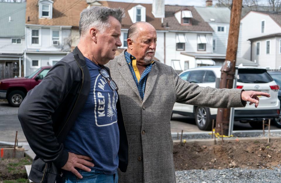 Michael Gorman, the project's designer, left, talks with Bernard Mazzocchi, right, at the former Fidelity Savings & Loan building they are renovating into a boutique hotel on Radcliffe St. in Bristol on Monday, Mar.4, 2024.