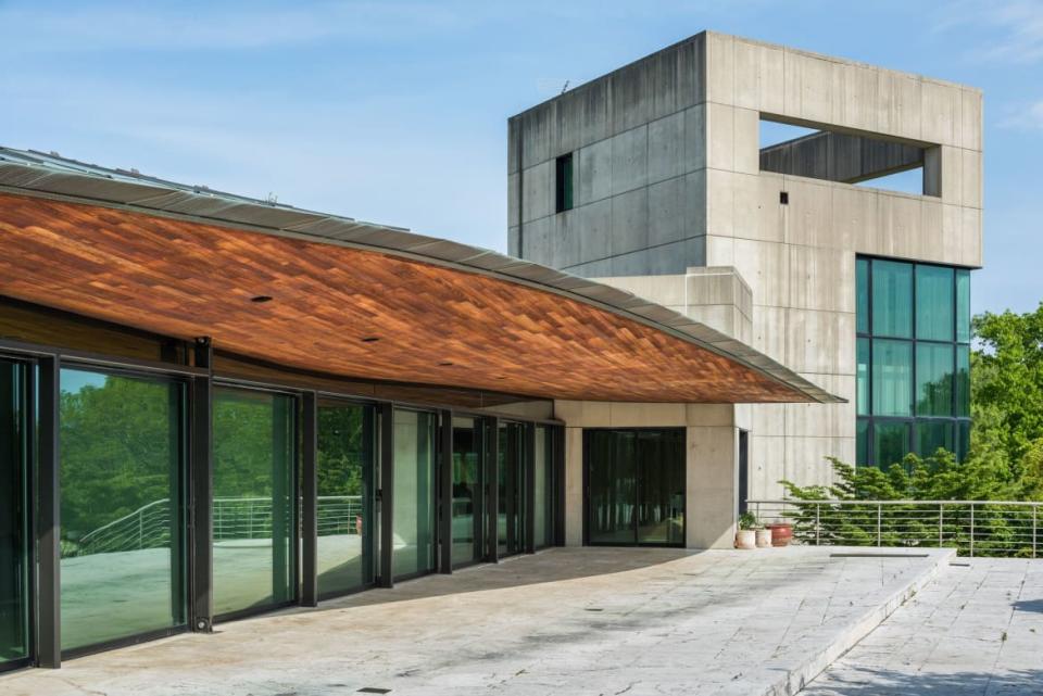 <div class="inline-image__caption"><p>Welcome to the second wing of the house, a concrete tower that holds the library, penthouse office, and observation deck. Naturally, the two sides are connected by a glassed-in walkway that houses the indoor pool. (Where else would you put it?)</p></div> <div class="inline-image__credit">Trulia</div>