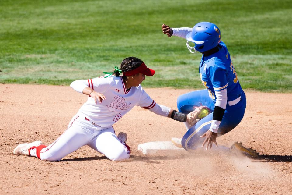 Utah infielder Aliya Belarde (23) attempts to tag out a sliding UCLA outfielder Lauren Hatch (30) during an NCAA softball game between Utah and UCLA at Dumke Family Softball Stadium in Salt Lake City on April 29, 2023.