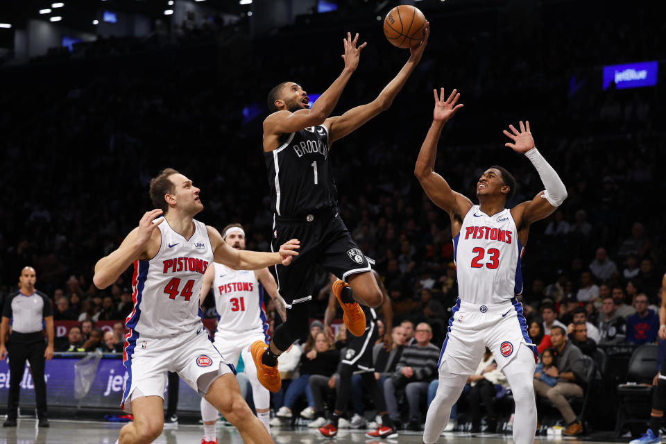 Brooklyn Nets forward Mikal Bridges (1) drives to the basket against Detroit Pistons forward Bojan Bogdanovic (44) and guard Jaden Ivey (23) during the first half of an NBA basketball game Saturday, Dec. 23, 2023, in New York. (AP Photo/Noah K. Murray)