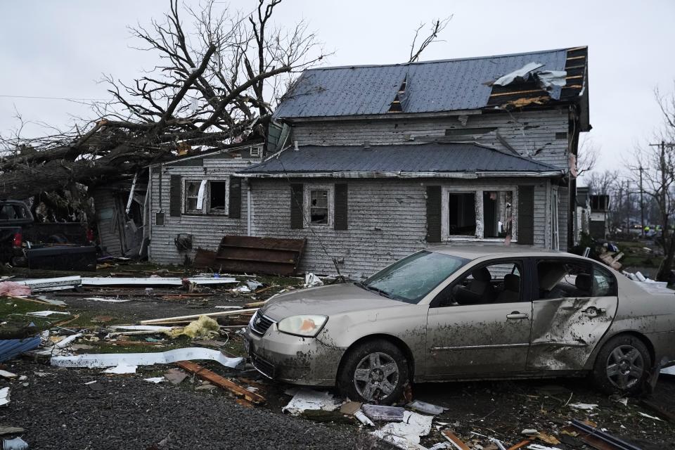 Debris is visible near a damaged home following a severe storm Friday, March 15, 2024, in Lakeview, Ohio. (AP Photo/Joshua A. Bickel)