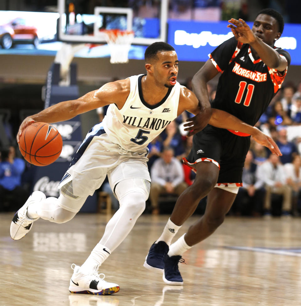 Villanova guard Phil Booth (5) moves past Morgan State guard Malik Miller (11) in the first half of an NCAA college basketball game, Tuesday, Nov. 6, 2018, in Villanova, Pa. (AP Photo/Laurence Kesterson)