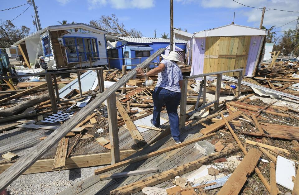 <p>Mirta Mendez walks through the debris at the Seabreeze trailer park along the Overseas Highway in the Florida Keys on Sept. 12, 2017. Florida is cleaning up and embarking on rebuilding from Hurricane Irma, one of the most destructive hurricanes in its history. (Photo: Al Diaz/Miami Herald/AP) </p>