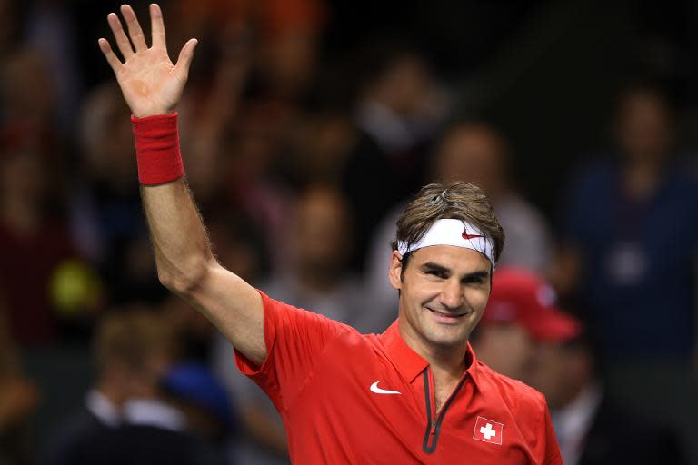 Switzerland's Roger Federer celebrates after beating Kazakhstan's Andrey Golubev during the Davis Cup World Group quarter-final match Switzerland vs Kazakhstan on April 6, 2014 in Geneva