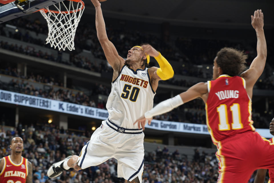 Denver Nuggets forward Aaron Gordon, left, is fouled by Atlanta Hawks guard Trae Young during the second half of an NBA basketball game Friday, Nov. 12, 2021, in Denver. (AP Photo/David Zalubowski)