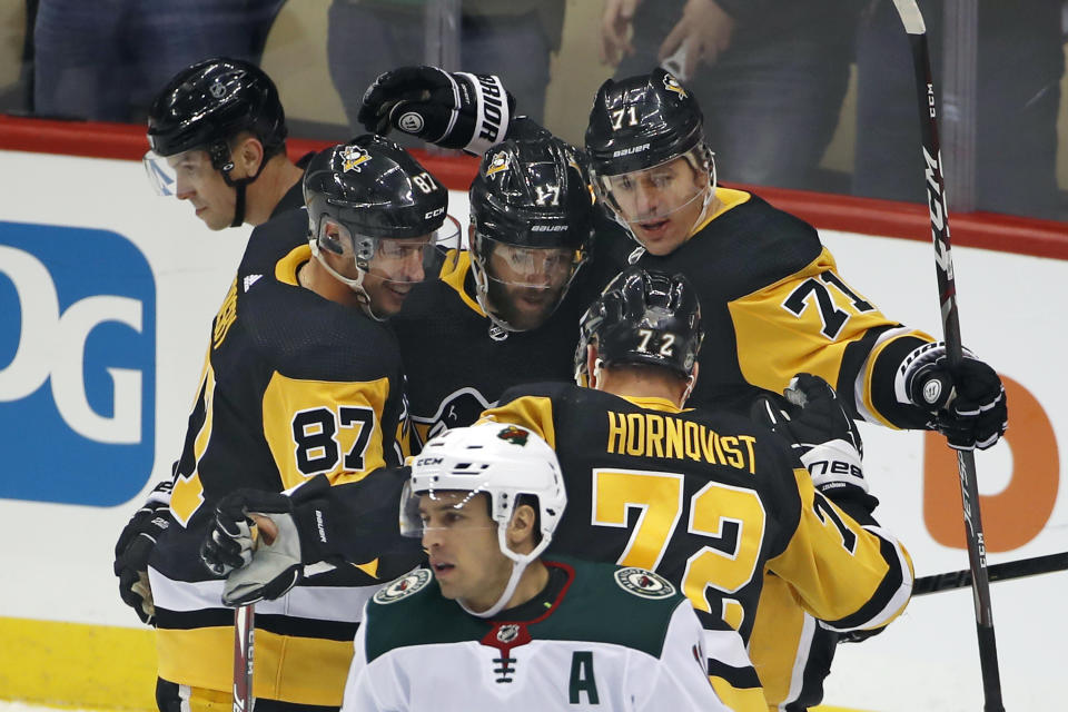 Pittsburgh Penguins' Evgeni Malkin (71) celebrates his goal with teammates, including Bryan Rust (17) and Sidney Crosby (87), during the first period of the team's NHL hockey game against the Minnesota Wild in Pittsburgh, Tuesday, Jan. 14, 2020. (AP Photo/Gene J. Puskar)