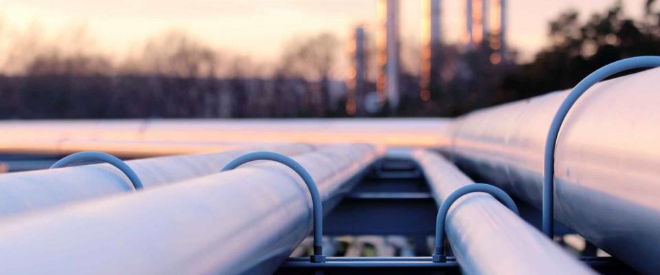 steel long pipes in crude oil factory during sunset