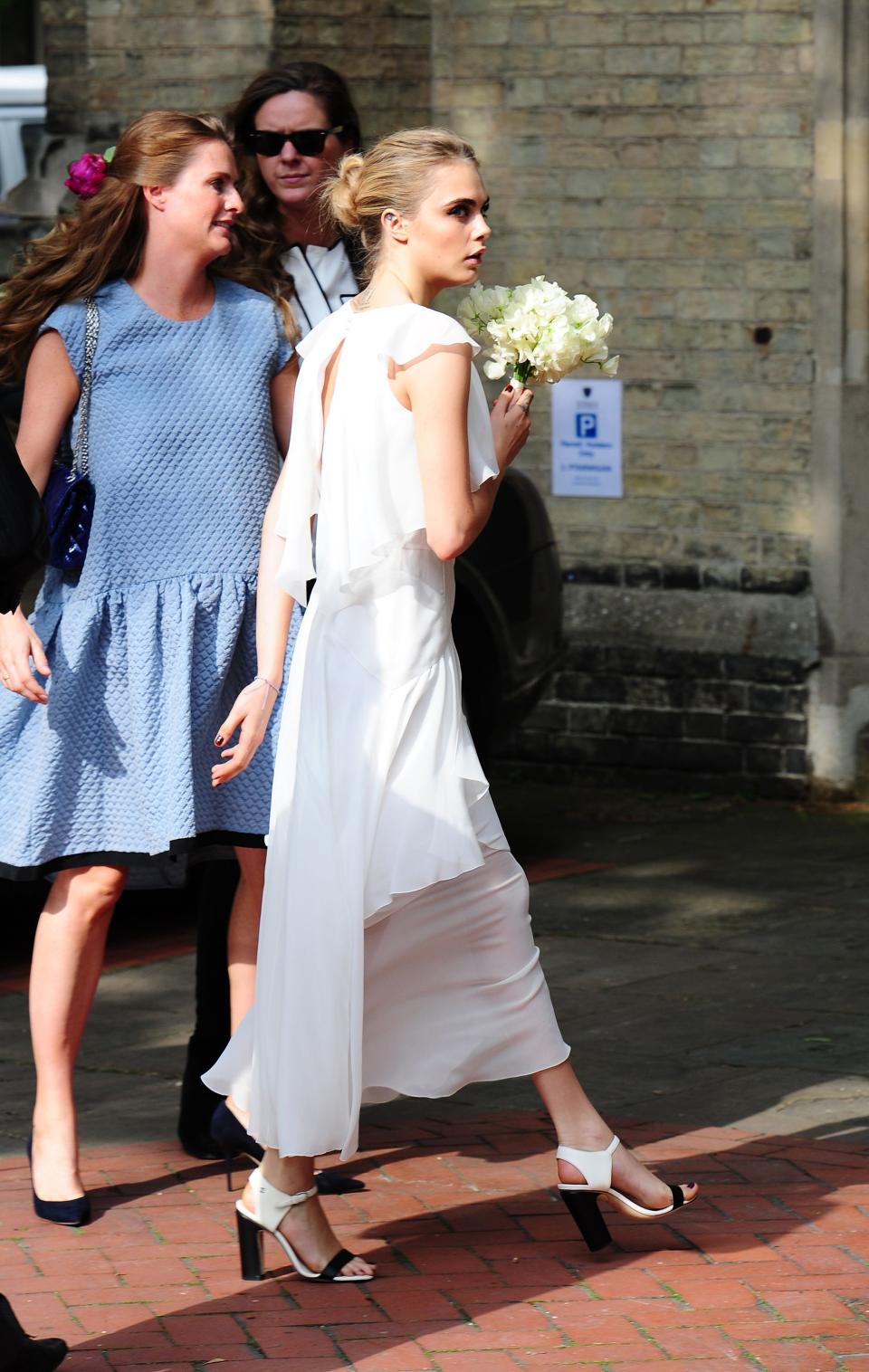 <p>Cara Delevingne was asked to be bridesmaid at her older sister Poppy’s wedding to James Cook. The ceremony took place at St.Paul’s Church in Kensington on May 16, 2014. The model-turned-actress donned a Chanel ruffled dress for the nuptials finished with monochrome shoes. <em>[Photo: Getty]</em> </p>