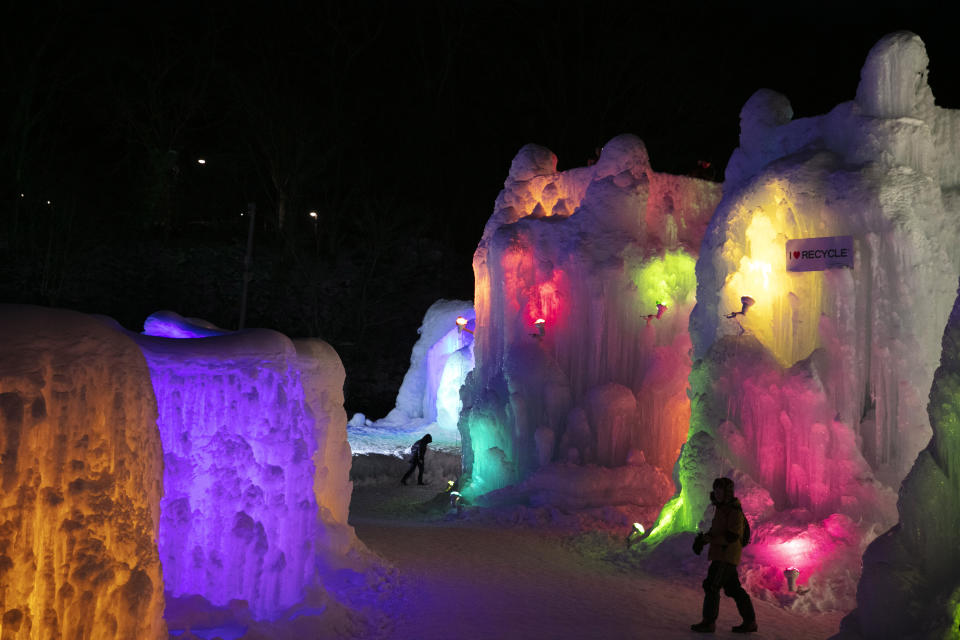 Tourist look at illuminated ice castles at the Lake Shikotsu Ice Festival in Chitose, Hokkaido, Japan, Feb. 6, 2020. (AP Photo/Jae C. Hong)