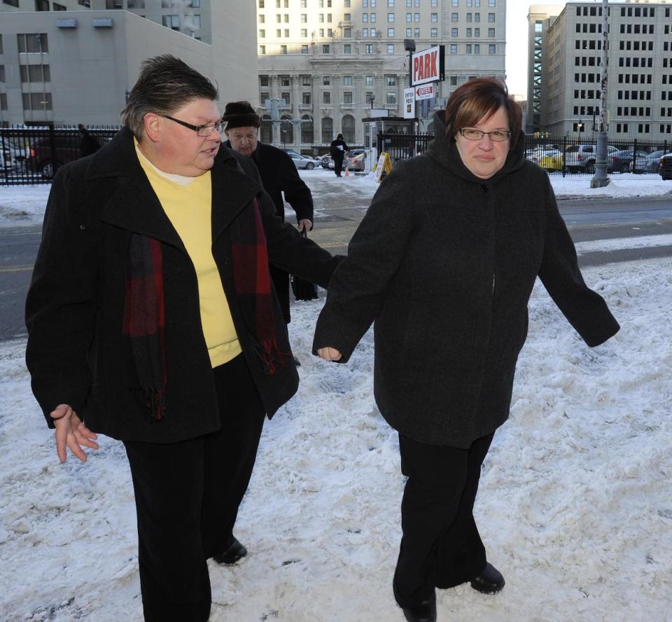 Jayne Rowse and April DeBoer walk outside Federal Courthouse before a trial that could overturn Michigan's ban on gay marriage in Detroit on Monday, March 3, 2014 in Detroit. Lisa Brown of Oakland County, the elected clerk of a Detroit-area county says she'll follow the orders of a judge when it comes to same-sex marriage, not Michigan's attorney general. Brown was asked about an email last fall from the attorney general's office, which warned county clerks not to issue marriage licenses to same-sex couples, even if a judge threw out the ban. Michigan voters banned gay marriage in 2004. In a lawsuit, Detroit-area nurses April DeBoer and Jayne Rowse say that violates the U.S. Constitution. (AP Photo/Detroit News, David Coates) DETROIT FREE PRESS OUT; HUFFINGTON POST OUT