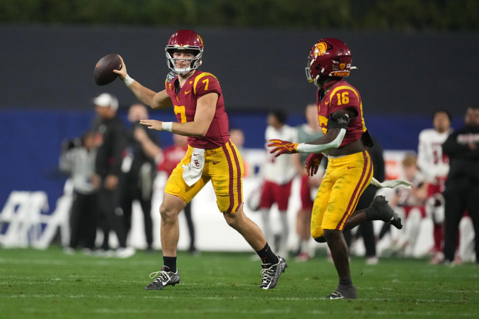 Dec 27, 2023; San Diego, CA, USA; Southern California Trojans quarterback Miller Moss (7) throws the ball to wide receiver Tahj Washington (16) in the second half against the Louisville Cardinals in the Holiday Bowl at Petco Park. Mandatory Credit: Kirby Lee-USA TODAY Sports