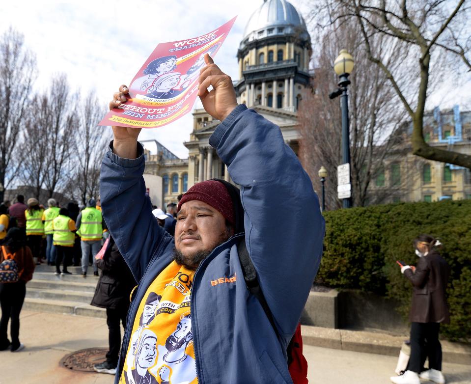 Gualverto Olac of Mexico holds up a sign during a immigration rally in front of the state Capitol Thursday, March 21, 2024, in Springfield.