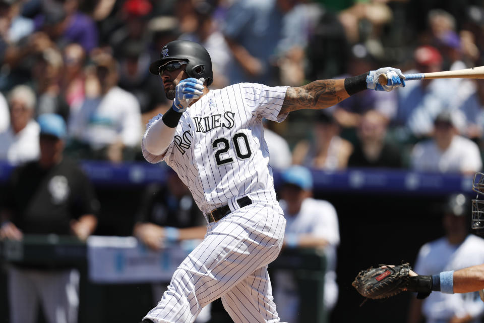 Colorado Rockies' Ian Desmond follows the flight of his RBI-double off San Diego Padres starting pitcher Nick Margevicius in the first inning of a baseball game Sunday, June 16, 2019, in Denver. (AP Photo/David Zalubowski)