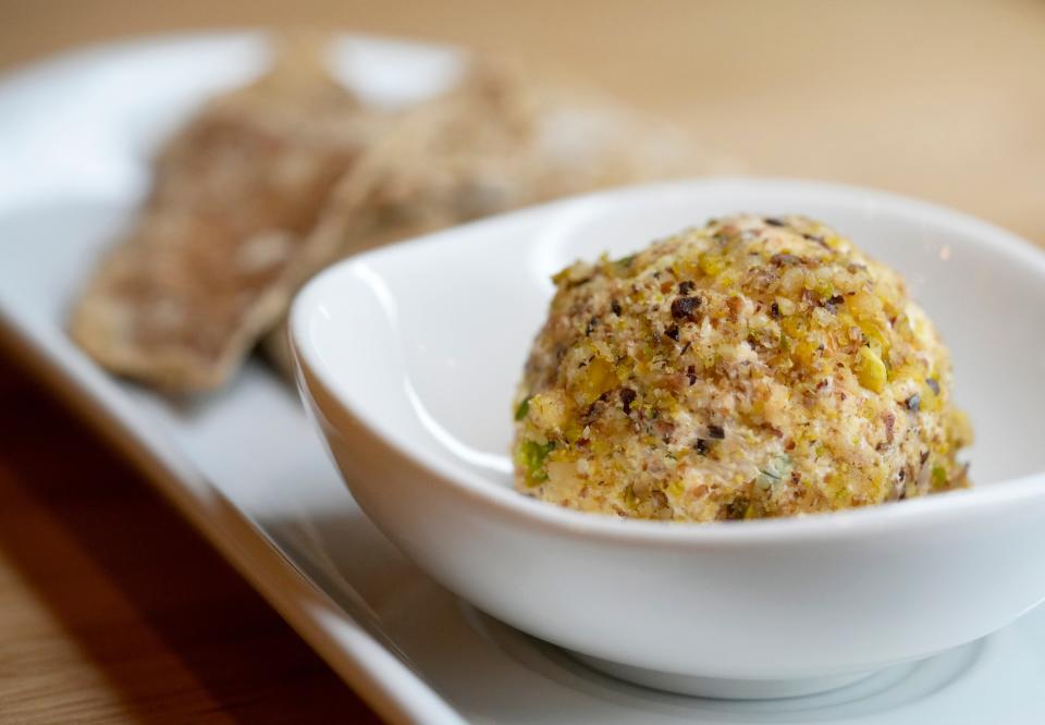 A cheeseball and crackers are part of  the four-course dinner.