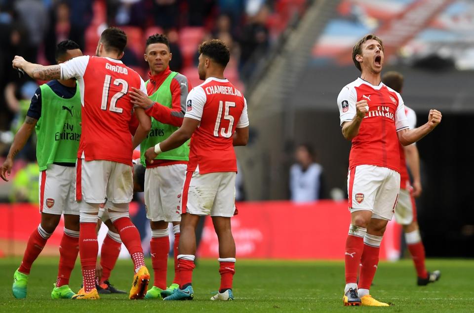  Nacho Monreal (R) and Arsenal players celebrate their 2-1 victory in the Emirates FA Cup Semi-Final match between Arsenal and Manchester City at Wembley Stadium