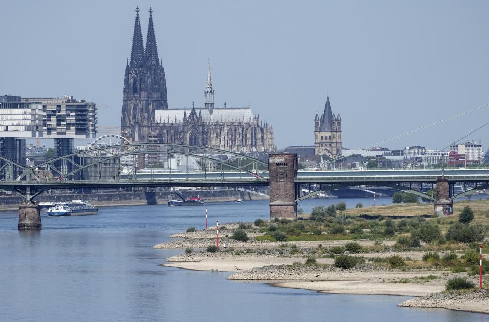 FILE - The river Rhine is pictured with low water in Cologne, Germany, Wednesday, Aug. 10, 2022. An unprecedented drought is afflicting nearly half of the European continent, damaging farm economies, forcing water restrictions and threatening aquatic species. Water levels are falling on major rivers such as the Danube, the Rhine and the Po. (AP Photo/Martin Meissner, File)