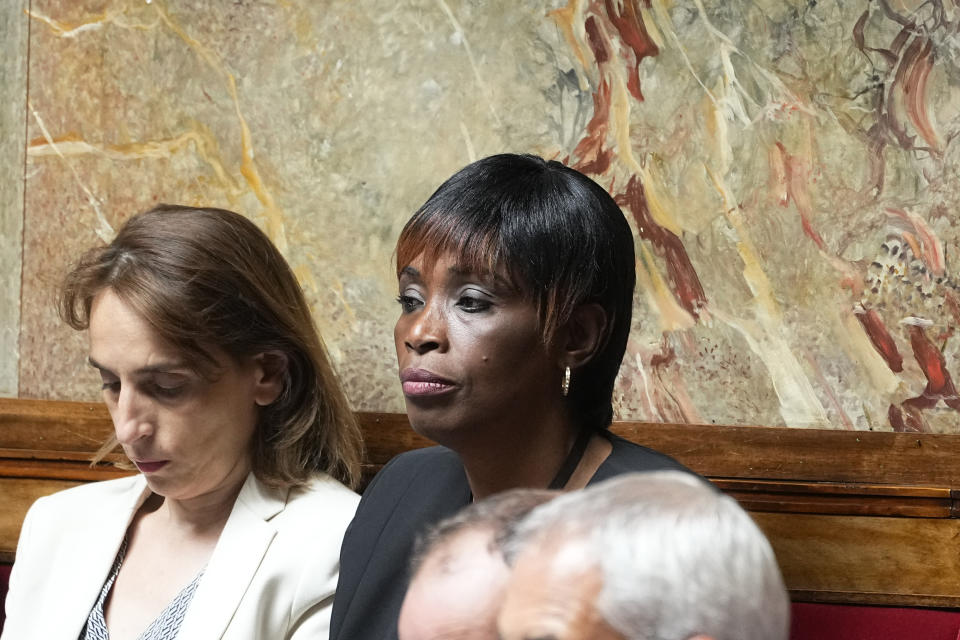 Hard-left newly elected parliament member Rachel Keke, center, sits at the National Assembly, Tuesday, June 28, 2022 in Paris. France's National Assembly convenes for the first time since President Emmanuel Macron lost his parliamentary majority. (AP Photo/Michel Euler)