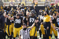 Iowa players wave to children in the University of Iowa Stead Family Children's Hospital at the end of the first quarter of an NCAA college football game against Northwestern, Saturday, Oct. 31, 2020, in Iowa City, Iowa. (AP Photo/Charlie Neibergall)