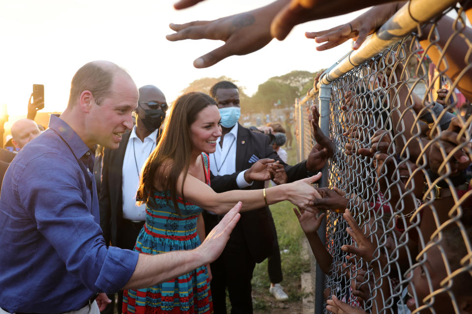 KINGSTON, JAMAICA &#x002013; MARCH 22: Prince William, Duke of Cambridge and Catherine, Duchess of Cambridge shake hands with children during a visit to Trench Town, the birthplace of reggae music, on day four of the Platinum Jubilee Royal Tour of the Caribbean on March 22, 2022 in Kingston, Jamaica. The Duke and Duchess of Cambridge are visiting Belize, Jamaica, and The Bahamas on their week-long tour. (Photo by Chris Jackson-Pool/Getty Images)