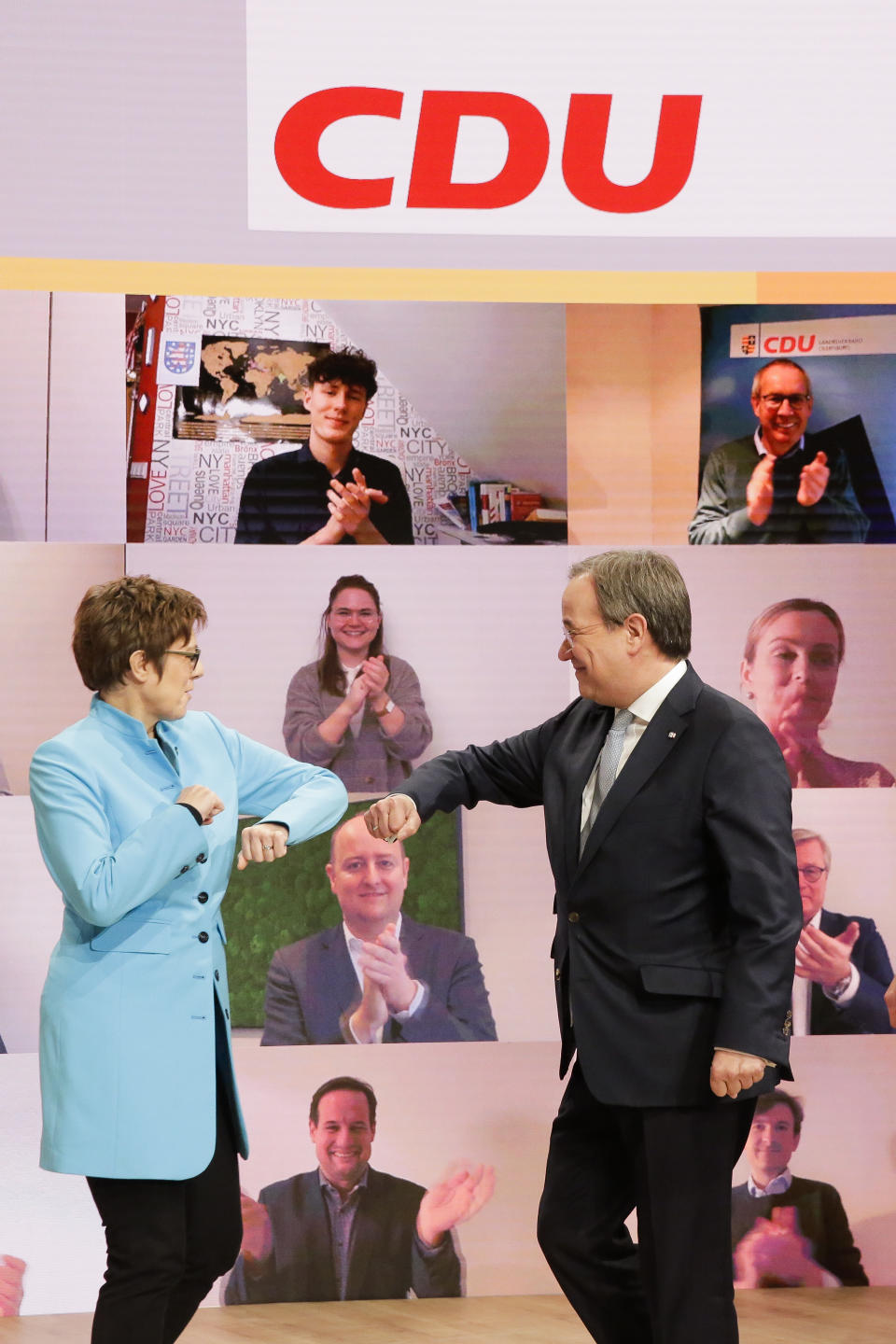 The new elected Christian Democratic Union, CDU, party chairman Armin Laschet, right, greets by outgoing chairwoman Annegret Kramp-Karrenbauer, left, after the voting at a digital party convention in Berlin, Germany, Saturday, Jan. 16, 2021. The party of German Chancellor Angela Merkel decided on a successor for the outgoing chairwoman Annegret Kramp-Karrenbauer, left, at the convention. (AP Photo/Markus Schreiber)