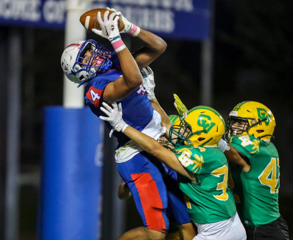 Indio's Jeremiah Cuahuey (4) makes a catch for a two-point conversion as he's hit by Coachella Valley's Jesus Verduzco (34) in the end zone during the third quarter of their game in Indio, Calif., Friday, Oct. 27, 2023.